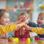 baby-friends-stacking-hands-together-happy-students-celebrating-together